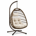 Poltrona sospesa con supporto, 105 × 105 × 195 cm, struttura in acciaio e rattan sintetico marrone, cuscini beige